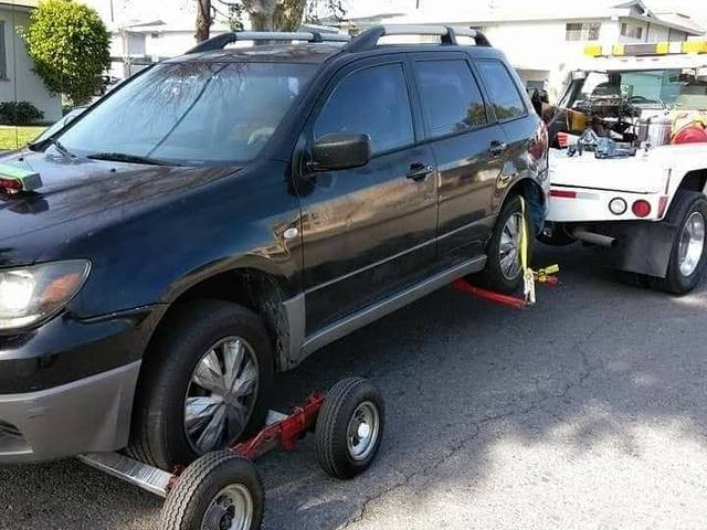 Budget Towing truck towing a Mitsubishi Outlander